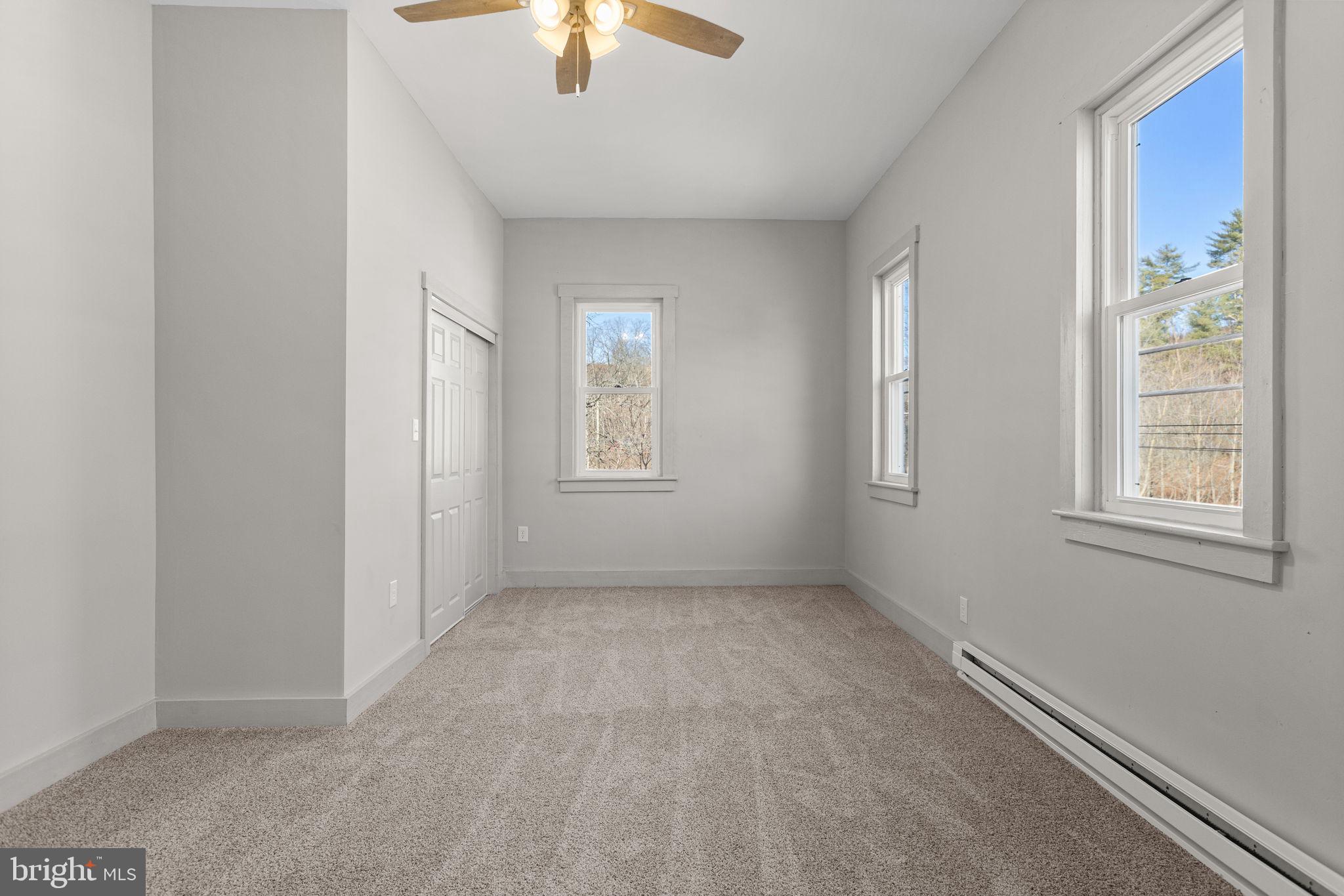 1586 Schwaben Creek Road Dornsife, PA 17823 - Photo 29 of 39 an empty room with windows and chandelier fan