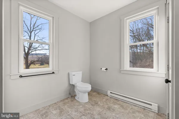 a bathroom with a toilet sink and window