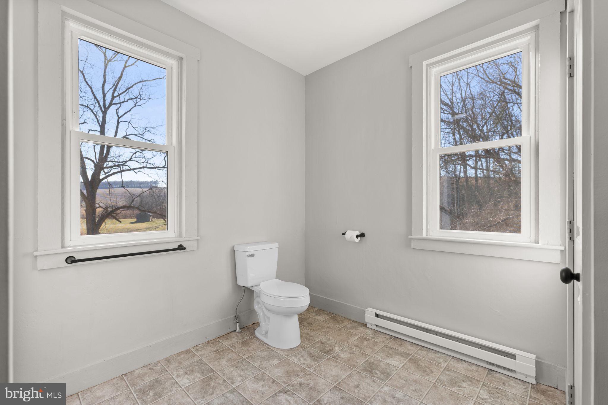 1586 Schwaben Creek Road Dornsife, PA 17823 - Photo 30 of 39 a bathroom with a toilet sink and window