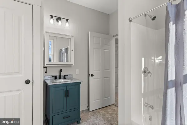 a bathroom with a double vanity sink a mirror and shower