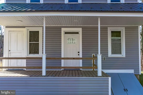 a view of a brick house with a door and chair