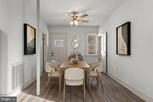 a view of a dining room with furniture and wooden floor