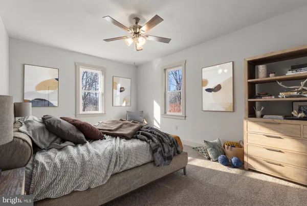 a bedroom with a large bed and a chandelier