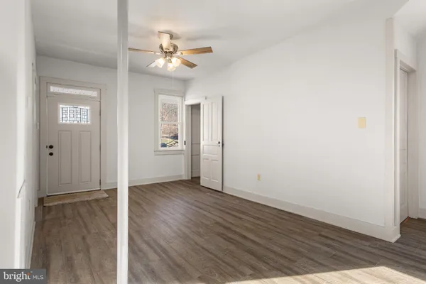 a view of an empty room with wooden floor