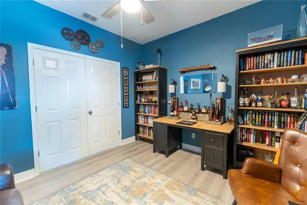 a view of a workspace with furniture and bookshelf