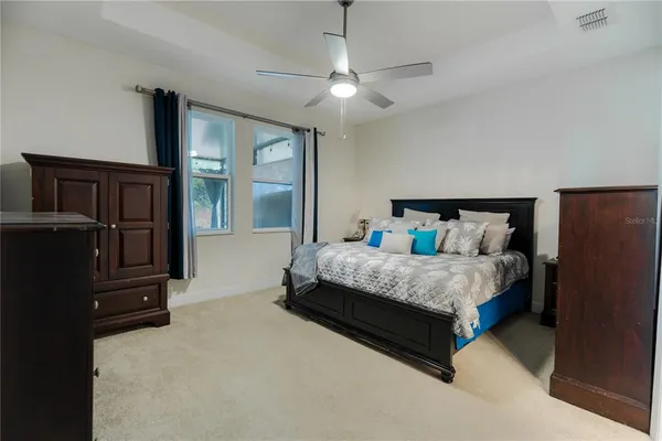 a bedroom with a bed dresser and a window