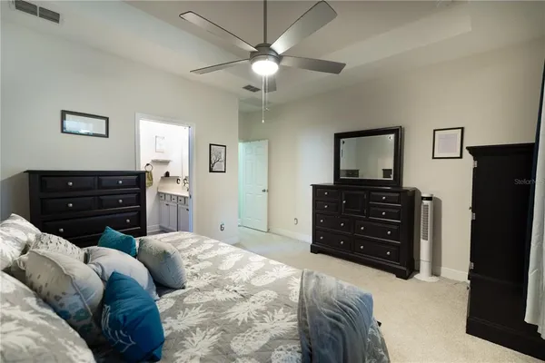 a bedroom with a bed and a dresser