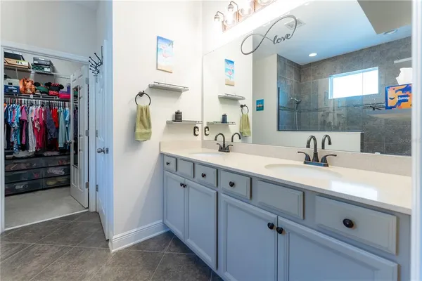 a bathroom with a sink vanity and mirror