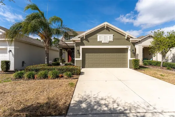 a front view of a house with a yard and garage