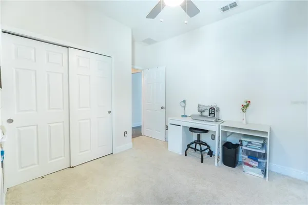 a dining room with furniture and large windows