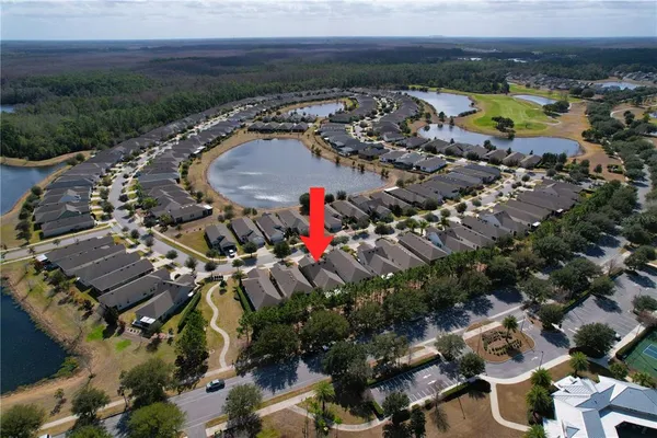 an aerial view of a house with a yard and lake view
