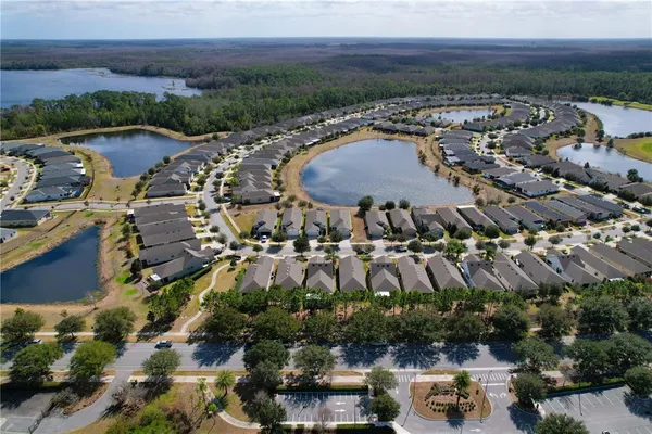 an aerial view of a house with a yard and lake view