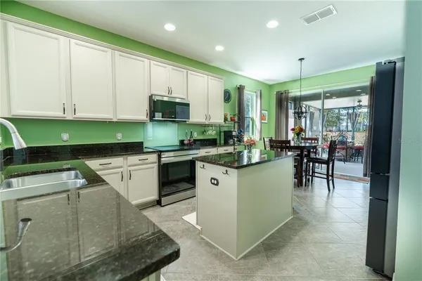 a kitchen with a stove a sink and a microwave