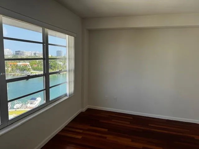 a view of an empty room and floor to ceiling window
