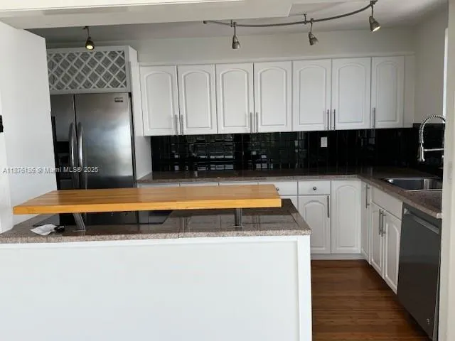 a view of a workspace with furniture and floor to ceiling window