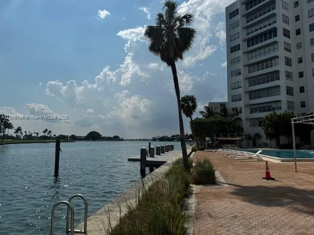 a bathroom with a granite countertop toilet sink and mirror