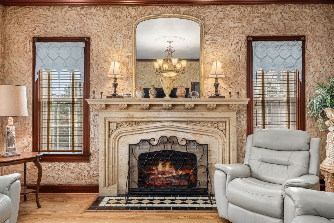 801 West Main Street Brenham, TX 77833 - Photo 11 of 50 Here is a closer look at the magnificent carved stone fireplace that serves as the focal point of the formal living room, showcasing intricate detailing and timeless craftsmanship. Flanked by tall windows, this striking feature adds character to the space.