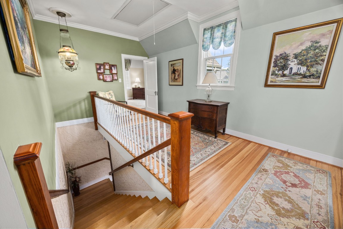 801 West Main Street Brenham, TX 77833 - Photo 24 of 50 Follow the staircase to the second floor where you will find the home's second primary suite along with the additional secondary bedrooms. The upstairs landing features beautiful long board pine floors, charming architectural details, and plenty of natural light.