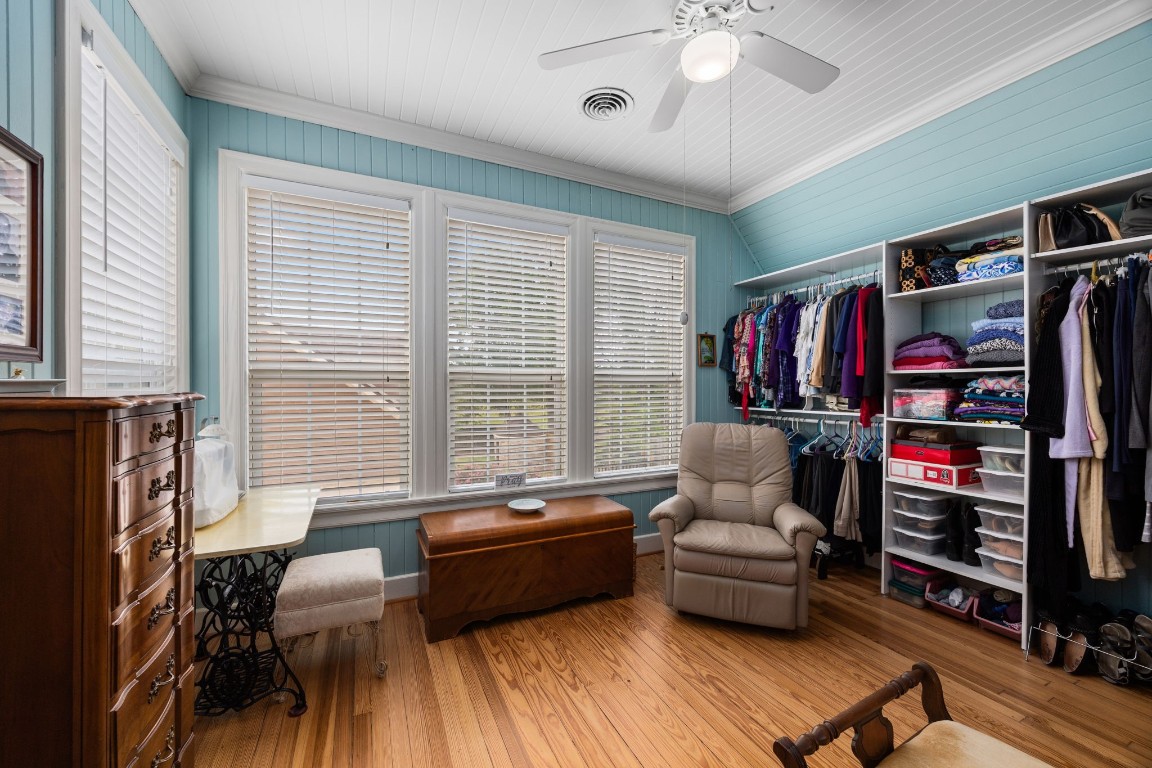 801 West Main Street Brenham, TX 77833 - Photo 28 of 50 Attached to the upstairs primary suite is an incredible dressing room or flex space complete with extensive built in closet storage, pine floors, and a wall of windows that fills the room with natural light. This versatile space could easily function as a dream closet, private sitting room, office, or nursery.