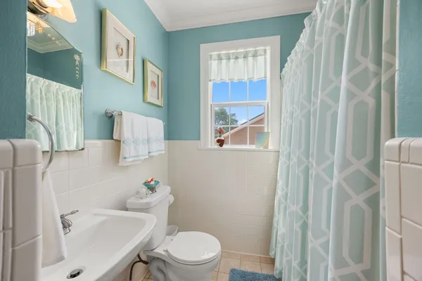 a white toilet sitting next to a bathroom sink
