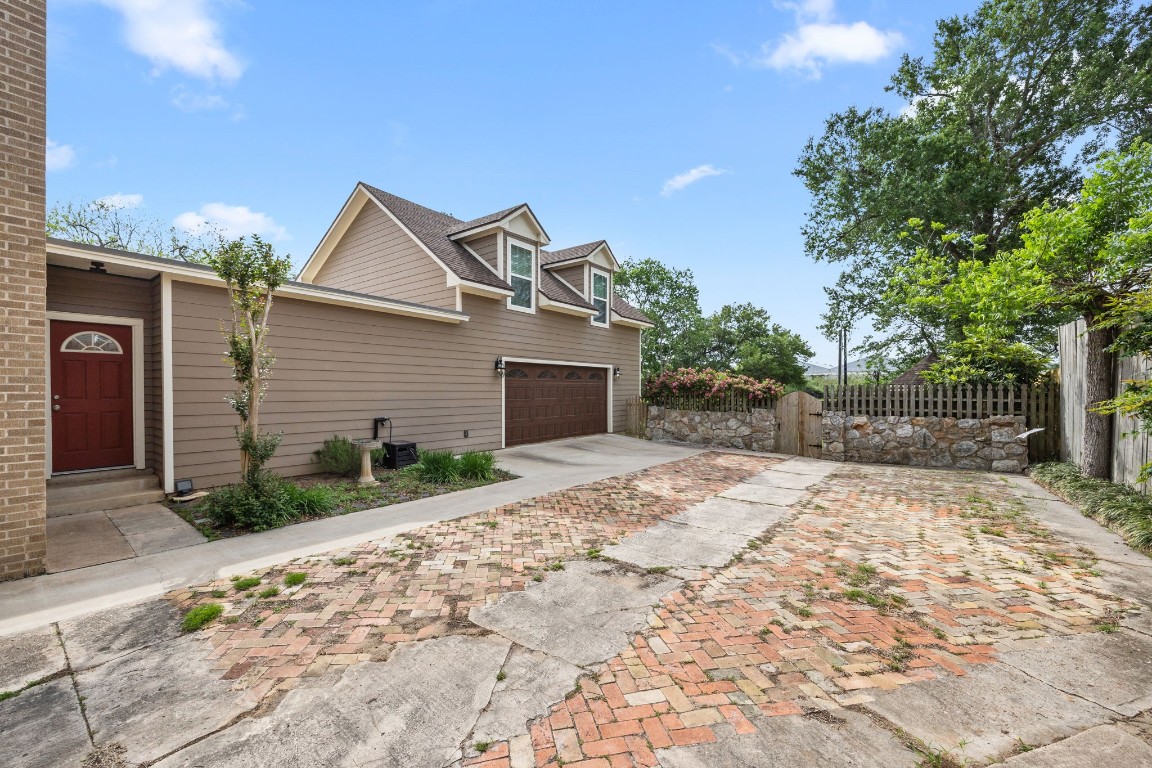 801 West Main Street Brenham, TX 77833 - Photo 42 of 50 The attached garage offers abundant parking and storage, while the expansive brick and concrete driveway provides additional space for guests, extra vehicles and more.