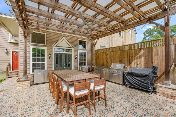 a outdoor space with patio lots of furniture and large tree