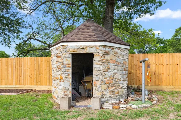 a stone house with trees in front of it