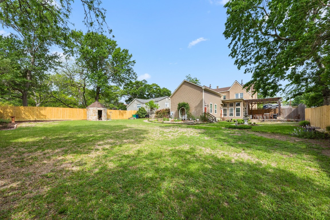 801 West Main Street Brenham, TX 77833 - Photo 47 of 50 Situated on an impressive .483 acre lot, the backyard offers an abundance of open green space, mature trees, beautiful landscaping, a covered entertaining area, and plenty of room to add a pool, play space, or garden.