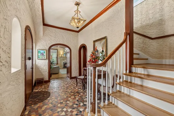 a view of staircase with wooden floor and a rug