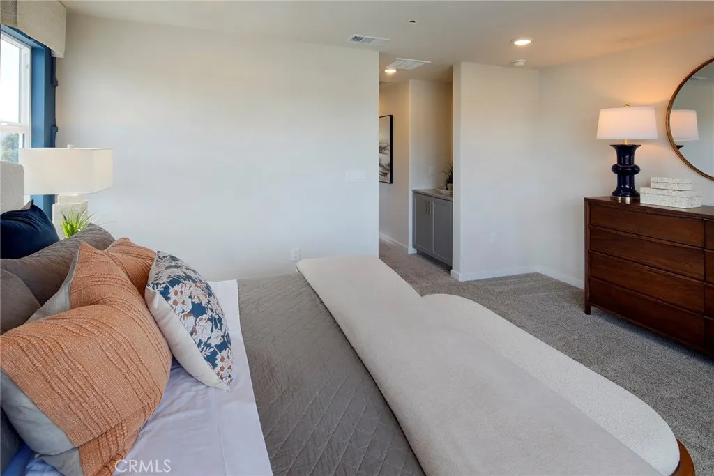 9520 Hannah Way Riverside, CA 92505 - Photo 18 of 22 a bedroom with a bed and a mirror