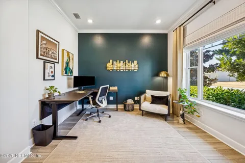 a kitchen with stainless steel appliances granite countertop a stove a sink dishwasher and a dining table with wooden floor