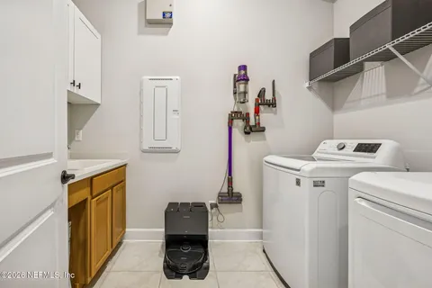 a living room with kitchen island furniture and a flat screen tv