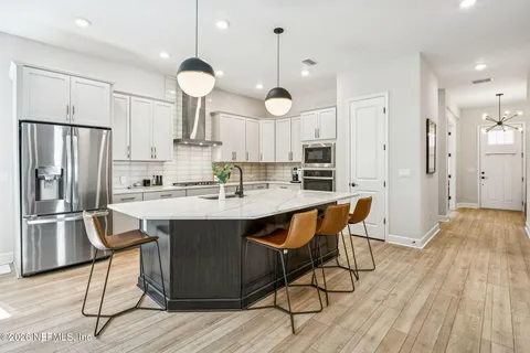 a view of a dining room with furniture wooden floor and chandelier