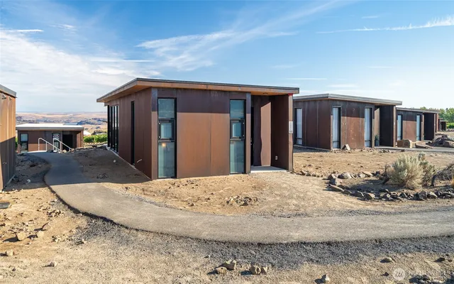 a view of a house with snow on the road