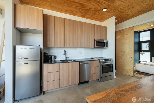 a kitchen with a refrigerator sink and stove top oven