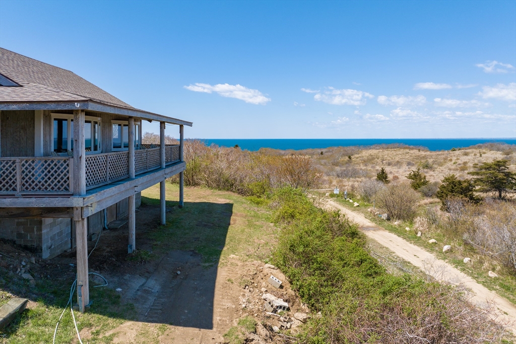 0 Bayberry Hill Road Cuttyhunk, MA 02713 - Photo 3 of 12 a balcony with table and chairs