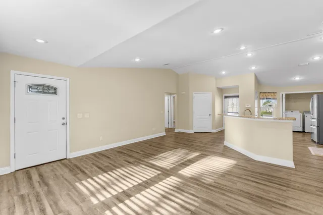 a view of a kitchen and a refrigerator in a room