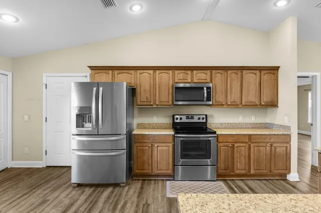 a kitchen with a refrigerator sink and microwave