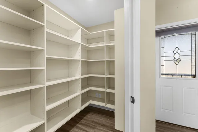 a view of walk in closet with empty racks