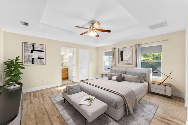 a bedroom with two beds and a potted plant