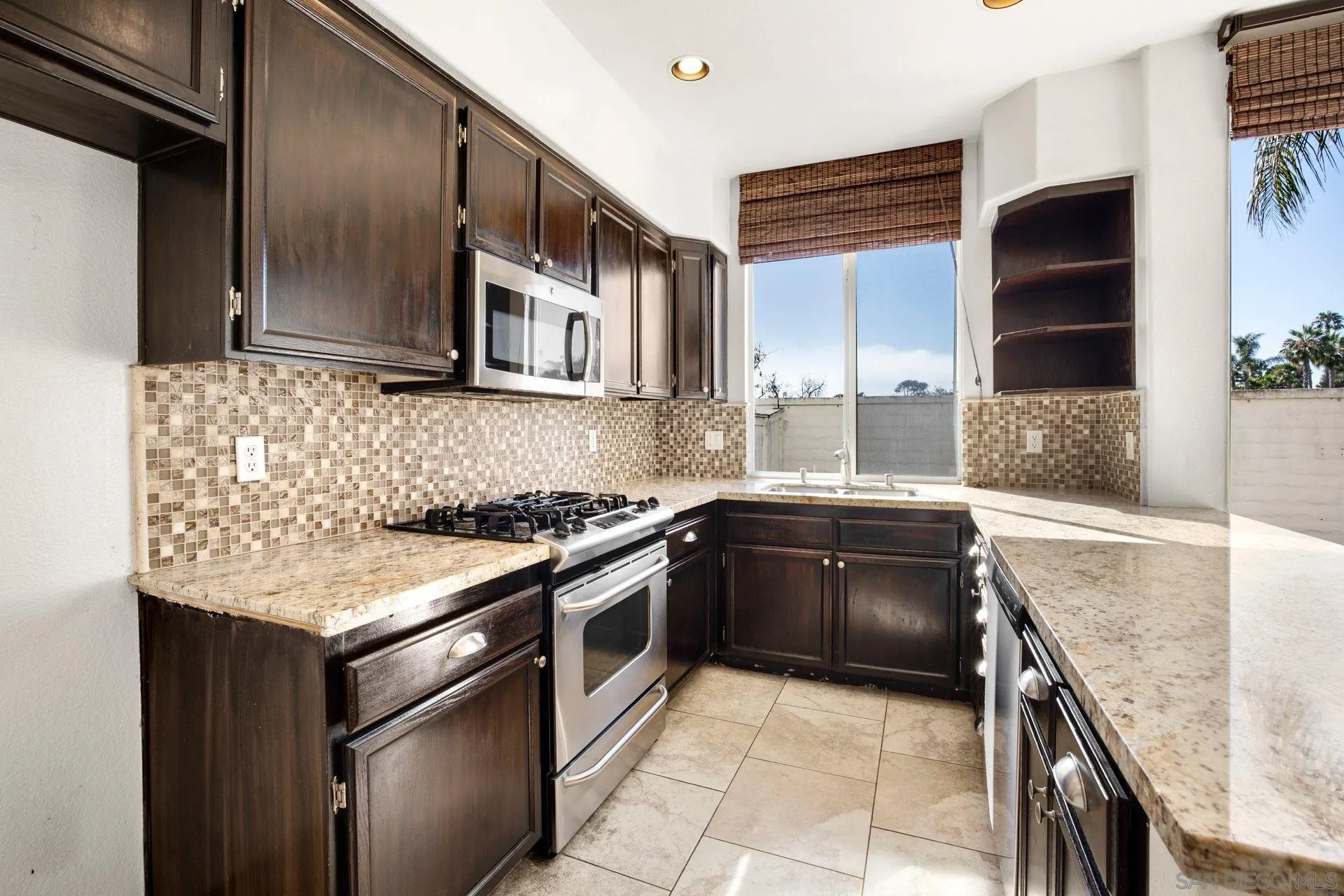 418 Carmel Creeper Place Encinitas, CA 92024 - Photo 19 of 31 a kitchen with granite countertop stainless steel appliances and wooden cabinets