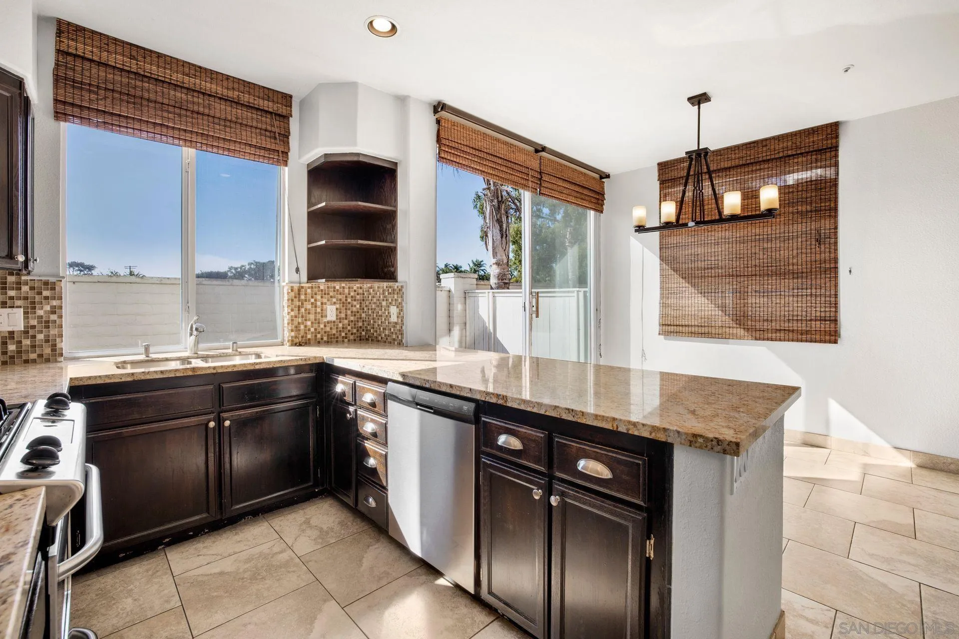 418 Carmel Creeper Place Encinitas, CA 92024 - Photo 20 of 31 a kitchen with stainless steel appliances granite countertop a sink and a stove