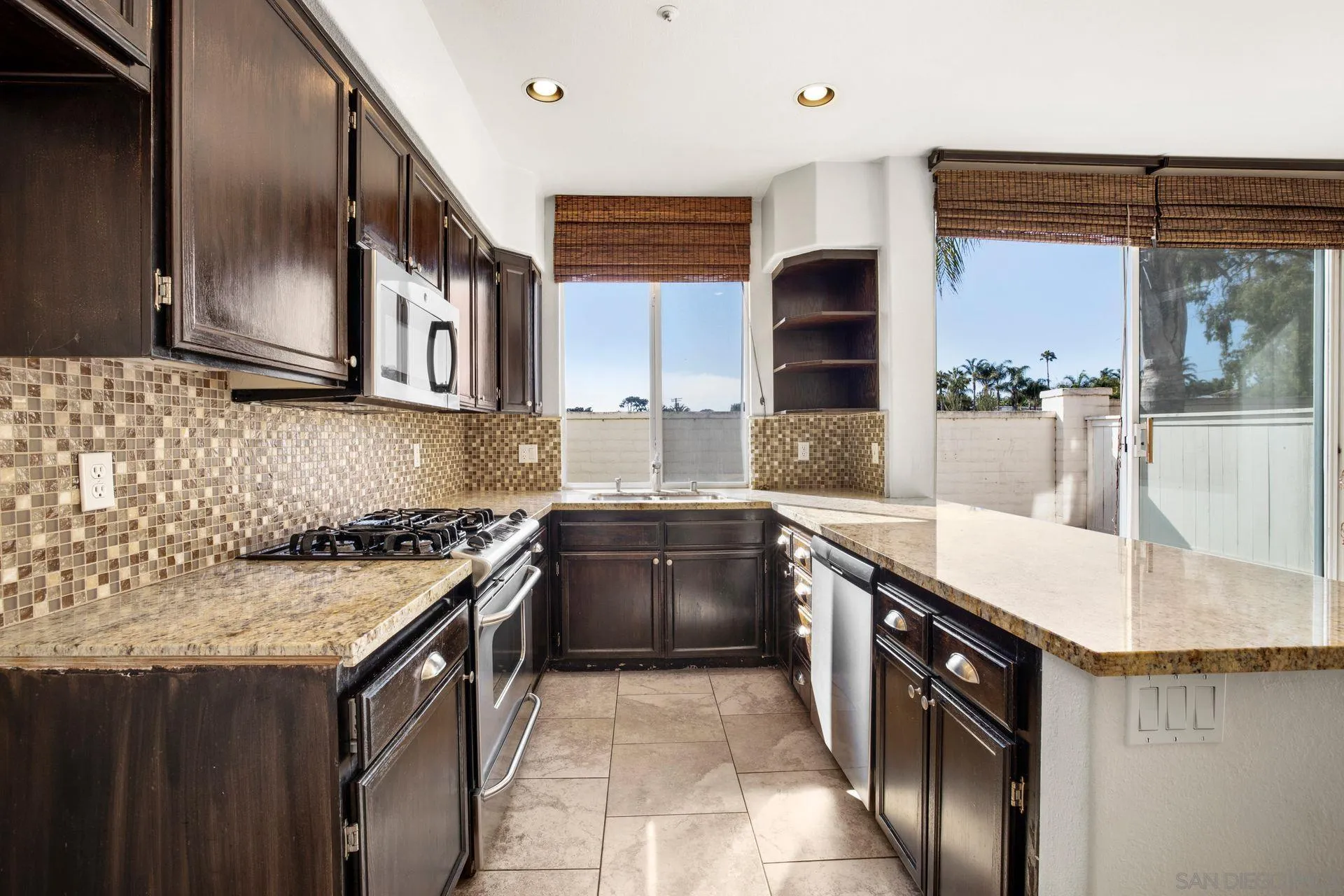 418 Carmel Creeper Place Encinitas, CA 92024 - Photo 21 of 31 a kitchen with stainless steel appliances granite countertop a sink stove and cabinets