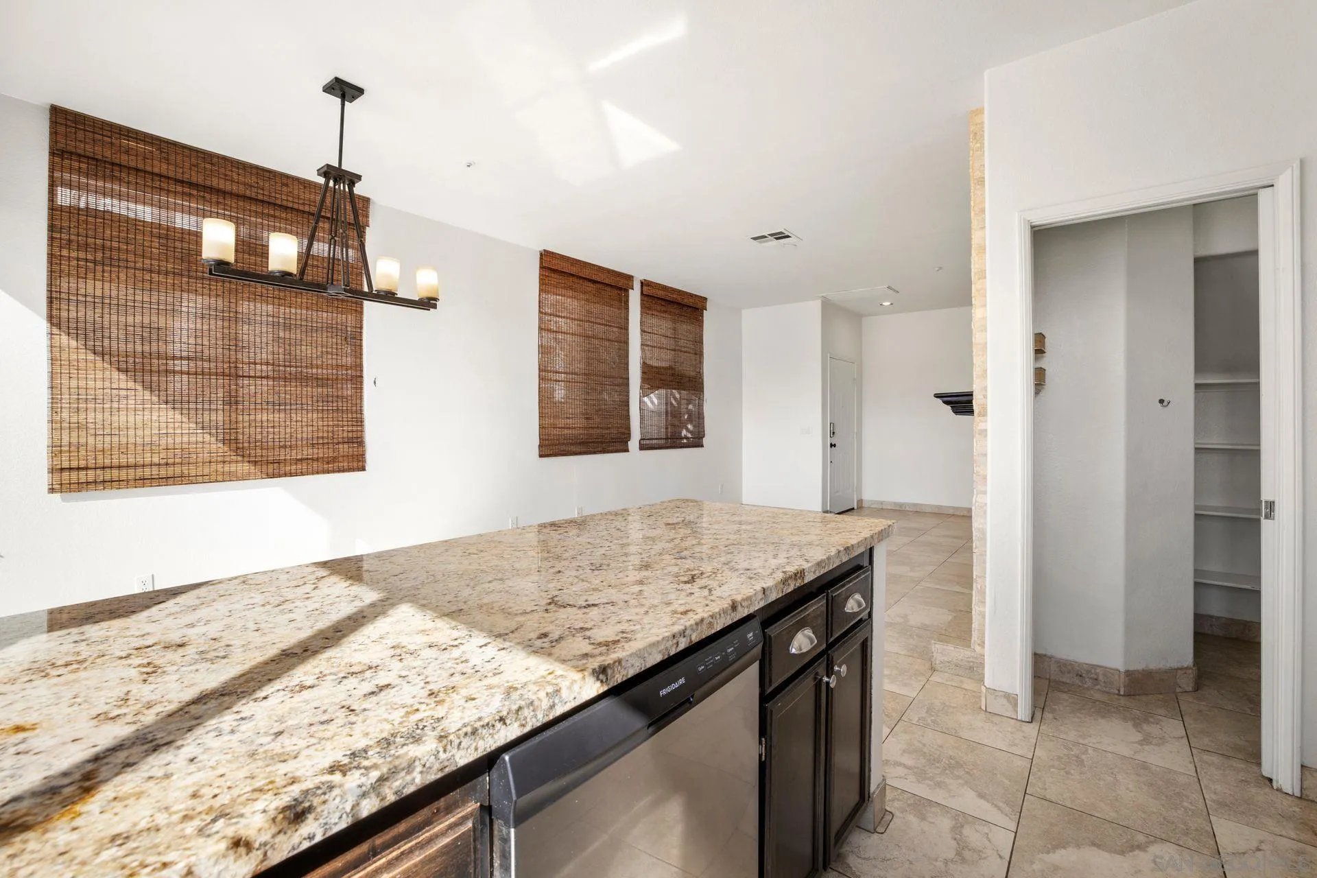 418 Carmel Creeper Place Encinitas, CA 92024 - Photo 22 of 31 a kitchen with granite countertop sink and refrigerator