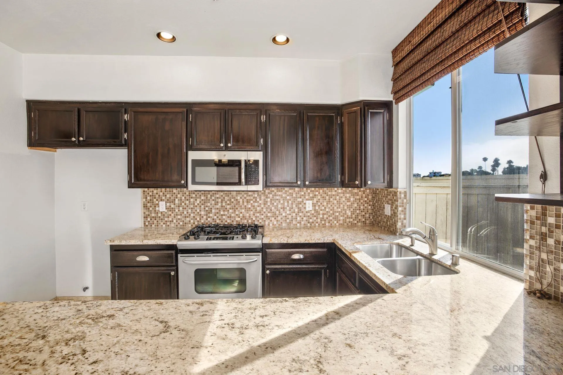 418 Carmel Creeper Place Encinitas, CA 92024 - Photo 23 of 31 a kitchen with stainless steel appliances granite countertop a sink stove and refrigerator