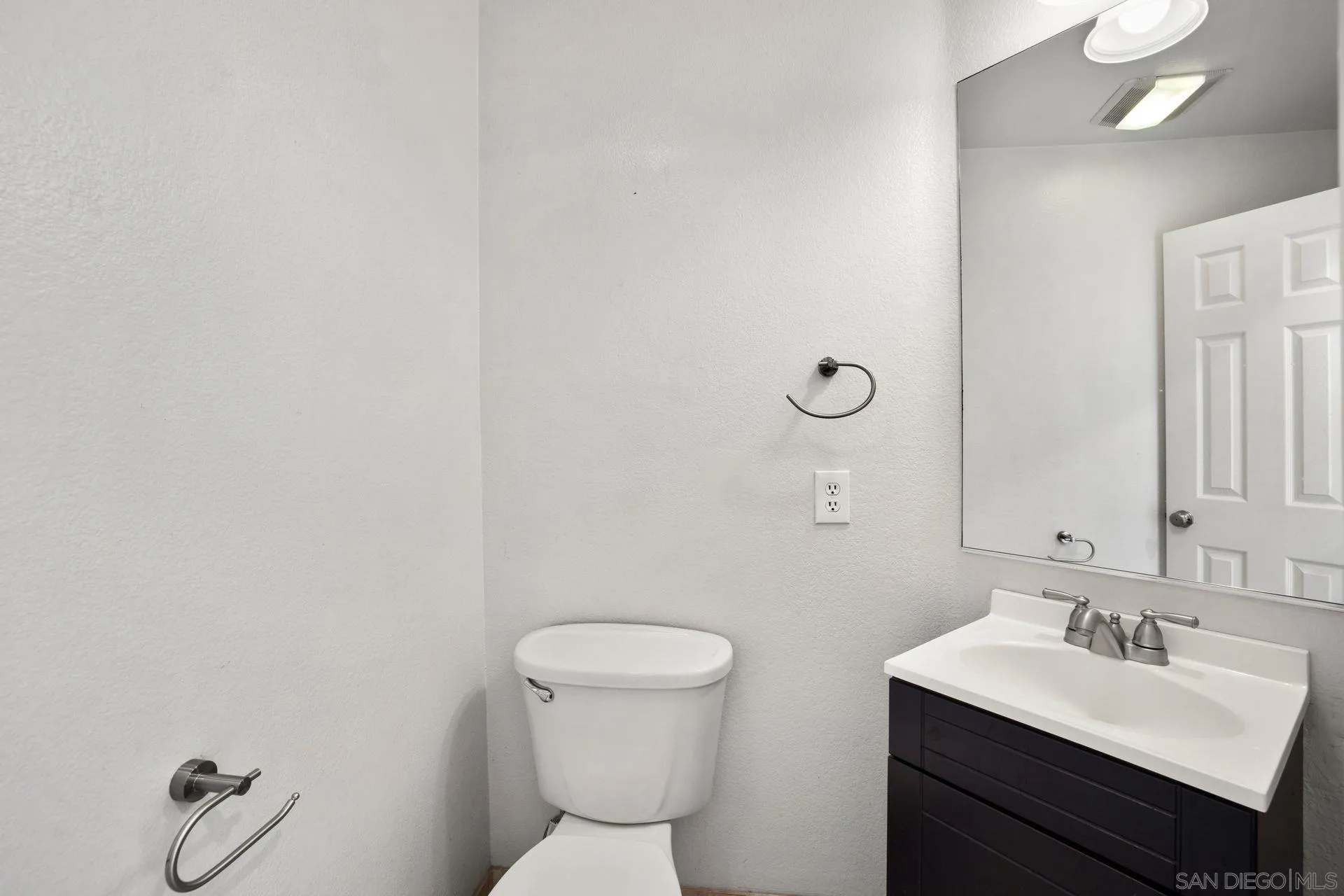 418 Carmel Creeper Place Encinitas, CA 92024 - Photo 30 of 31 a bathroom with a toilet sink and mirror
