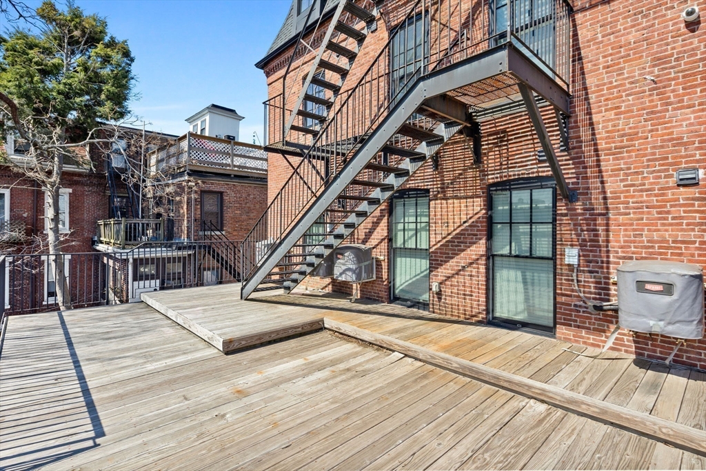 105 Broadway, Unit 3 Chelsea, MA 02150 - Photo 13 of 14 a view of a house with wooden stairs