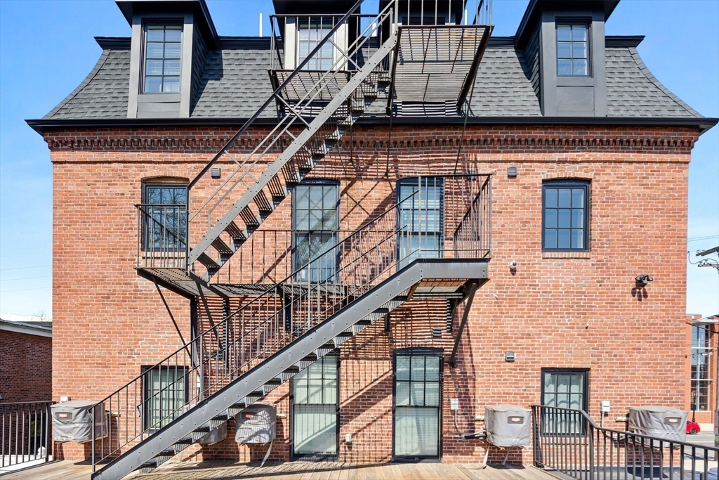 105 Broadway, Unit 3 Chelsea, MA 02150 - Photo 14 of 14 a front view of a house with wooden stairs
