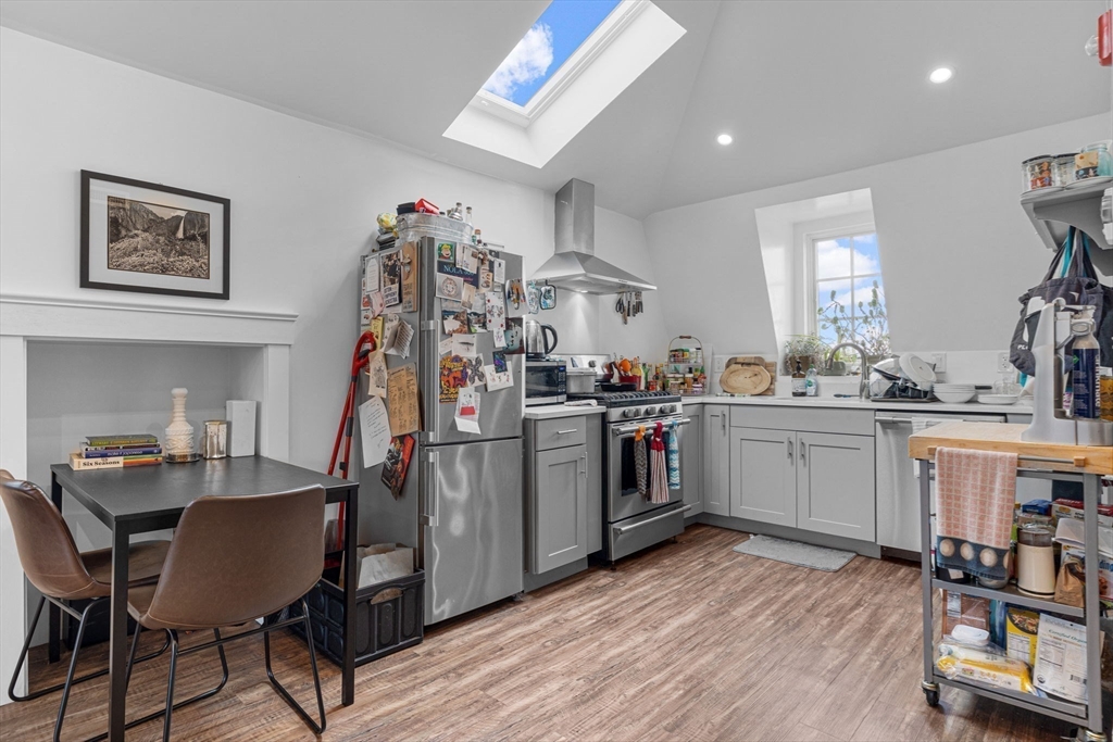 105 Broadway, Unit 3 Chelsea, MA 02150 - Photo 2 of 14 a kitchen that has a lot of cabinets a sink and appliances in it