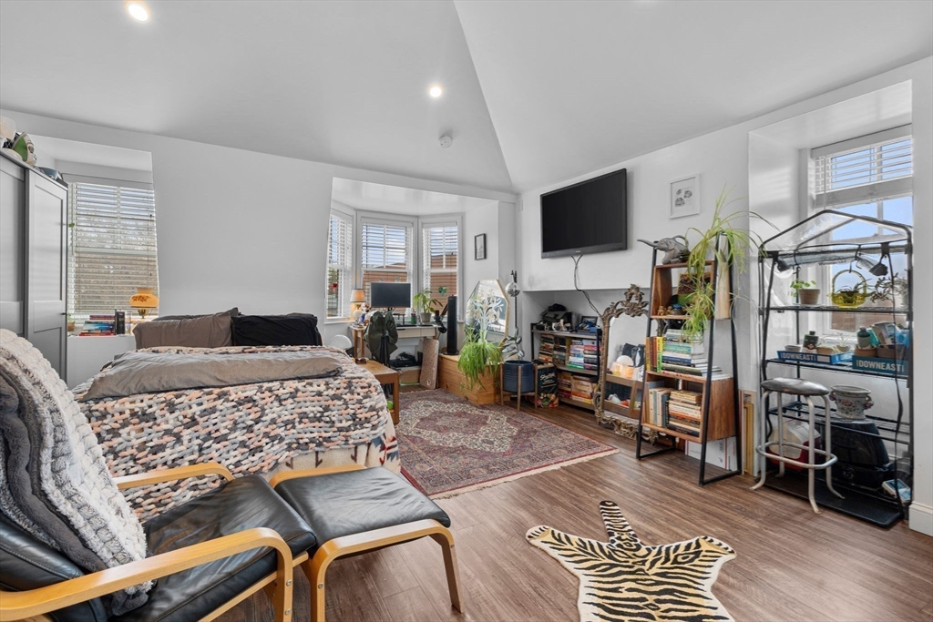 105 Broadway, Unit 3 Chelsea, MA 02150 - Photo 4 of 14 a bedroom with furniture and a flat screen tv
